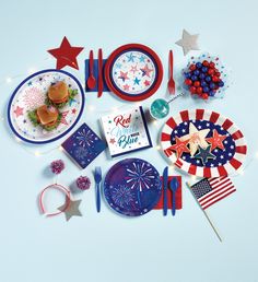 an american themed table setting with plates, napkins, and confetti for fourth of july