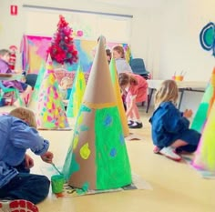 the instagram page shows children playing with paper cones and other crafting materials in an art class