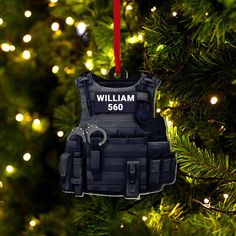 an ornament hanging from a christmas tree that says william 650 on it's back