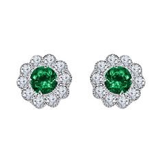 Presenting these stunning earrings showcasing two round-cut emerald centers, enveloped by a halo of round natural diamonds. Delicate milgrain detailing throughout the design enhances its overall floral aesthetic. The total emerald weight is 0.95 carats, complemented by a combined diamond weight of 0.52 carats, all elegantly set in 14k white gold. An insurance appraisal will be included with your purchase. At DiamondTown, we take immense pride in presenting our extensive range of exquisite fine j Emerald Earrings Studs, Emerald Earrings, Diamond Drops, Yellow Gold Earring, Diamond Drop Earrings, Stunning Earrings, Gold Drop Earrings, Emerald Diamond, Flower Fashion