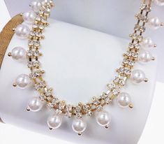 the necklace is adorned with pearls and diamonds