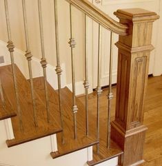 a wooden staircase with metal handrails in a home