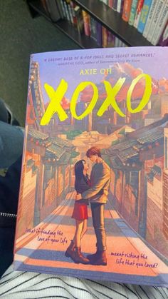 a person holding up a book about xoxo