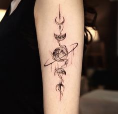 a woman with a tattoo on her arm that has an image of the earth and moon