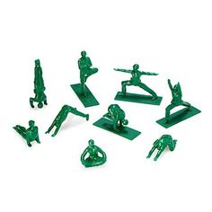 green plastic figurines are arranged in the shape of people doing different things on white background