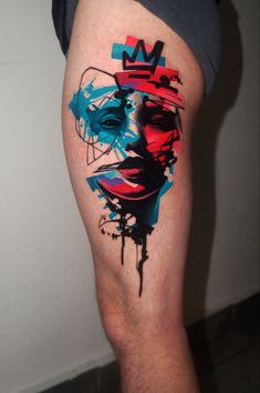 a man's leg with a colorful face on it