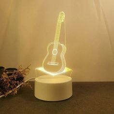 a guitar shaped lamp sitting on top of a table