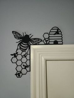 the wall is decorated with black bees and honeycombs