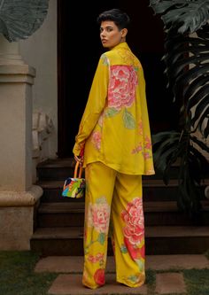 The lime yellow big floral co-ord set is inspired from fresh blooming spring flowers. The print has been converted from hand painted floral motifs into digital sketch and it has been printed using digital print technique. The set features a strappy blouse, straight cut trouser pants and we've paired it with shirt which is adorned using shell buttons. Paulmi And Harsh, Two Piece Sets Outfits, Strappy Blouse, Spring Floral Prints, 1950’s Fashion, Straight Cut Pants, Lime Yellow, Padded Blouse, Shirt Pant Set