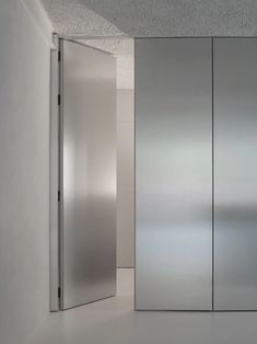 an empty room with glass doors and white walls