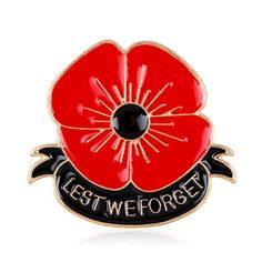 a red poppy flower pin with the words, let we forget