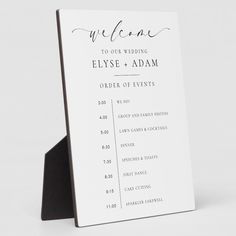 a white and black wedding welcome card with the word welcome written on it in cursive font