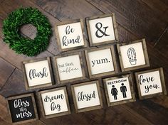 christmas signs are displayed on a wooden table