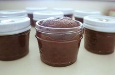 several jars filled with chocolate pudding sitting on top of a table