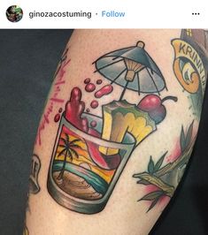 a close up of a person's arm with tattoos on it and an umbrella