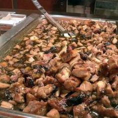 a large pan filled with meat sitting on top of a counter