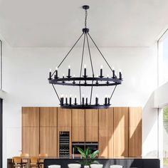 a dining room table with chairs and a chandelier hanging from it's ceiling