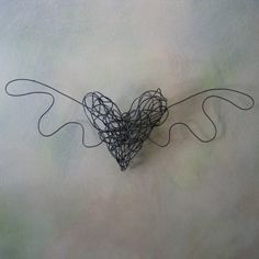 a heart shaped sculpture made out of wire