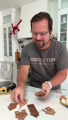 a man is making gingerbread cookies in the kitchen