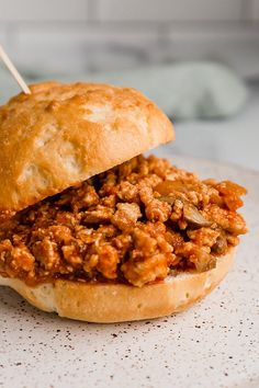 a sloppy joe sandwich with toothpicks in it's mouth on a plate