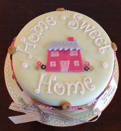 a cake that is sitting on top of a table with the words home sweet home