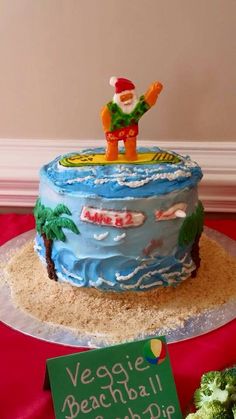 there is a cake that has been decorated to look like a man on the beach