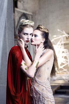 two women dressed in red and white posing for the camera