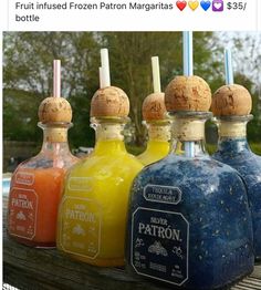 four bottles with different colored liquids in them