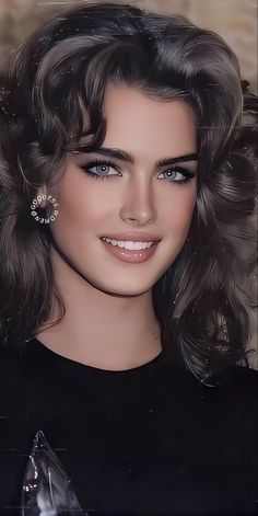 a close up of a person wearing a black shirt and earrings with hair in the wind