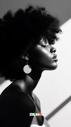 a woman with an afro and earrings on her head looking off to the side in black and white