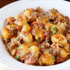 a white bowl filled with food on top of a table