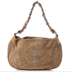 This Authentic Lovely Chanel Hobo Is Crafted Of Light Brown Suede Leather With A Camellia Flower Design. The Bag Features A Wide Leather Threaded Chain Link Handle With Polished Silver Links. The Top Zipper Opens To A Beige Chanel Cc Textile With A Zippered Pocket. This Is A Sophisticated Chanel, Both Edgy And Feminine And And Suitable For All Occasions. Excellent Condition Measurements Base Length: 10.5 In Height: 7 In Width: 3 In Drop: 7 In Chanel Small Hobo Bag, Chanel Taupe Bag, Beige Chanel Bag, Chanel Cream Bag, Light Gold Chanel Bag, Thread Chains, Cream Bags, Leather Thread, Camellia Flower