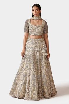 Ivory lehenga with tone to tone thread work, highlighted with pipes, crystals and pearls. Comes with blouse and dupatta with cut-work border and buttis.
Component: 3
Pattern: Hand Embroidered
Type Of Work: Threads, Pipes, Crystal, Pearls
Neckline: Sweetheart
Sleeve Type: Half
Fabric: Net, Lining: Raw Silk 
Color: Ivory
Other Details: 
Floral motifs
Back tassel tie-up
Cutwork hem lehenga
Sheer dupatta
Occasion: Bride, Wedding - Aza Fashions Blouse Organza, Ivory Lehenga, Sheer Dupatta, Lehenga And Blouse, Gold Organza, Leather Applique, Gold Lehenga, Organza Lehenga, Pink Lehenga