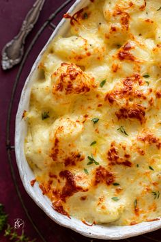 a casserole dish with cheese and herbs