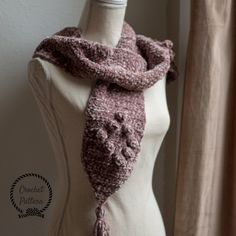 a crocheted scarf on top of a mannequin