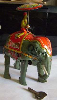 an elephant figurine with a man riding on top of it's back