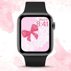 an apple watch with a pink bow on it's face and the time displayed