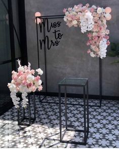 two vases filled with flowers sitting next to each other on top of a tiled floor