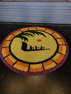 a door mat with the image of a boat and people on it in front of a window