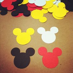 mickey mouse cut outs are sitting on the floor next to some other pieces of paper