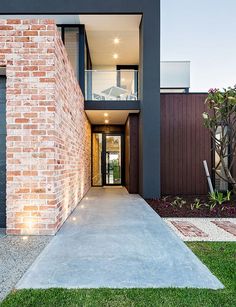 a modern house with brick and glass walls