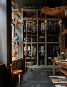 the closet is full of clothes and wooden ladders for hanging on the wall,