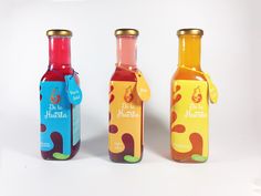 three bottles with different flavors and designs on them, one is red, one is blue