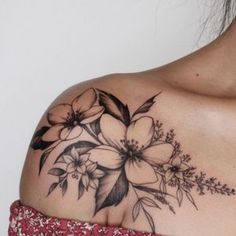 a woman with a flower tattoo on her shoulder