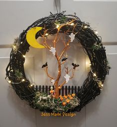 a wreath is decorated with branches and lights