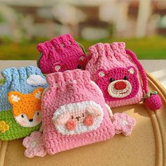 three crocheted purses sitting on top of a table