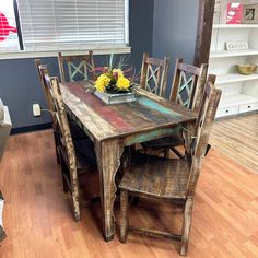 a wooden table and chairs in a room