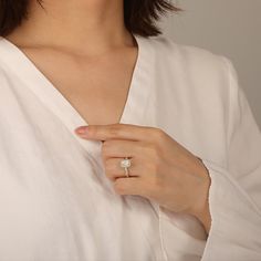 a woman wearing a diamond ring on her finger