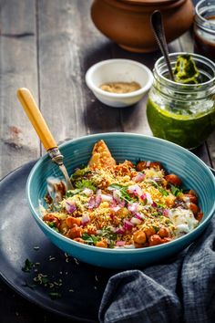 a blue bowl filled with food on top of a wooden table