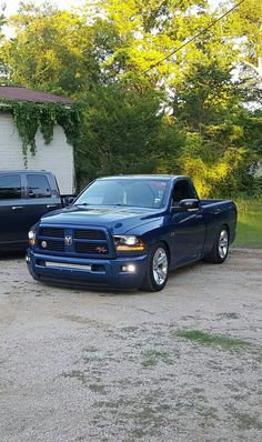 two trucks parked in front of a house